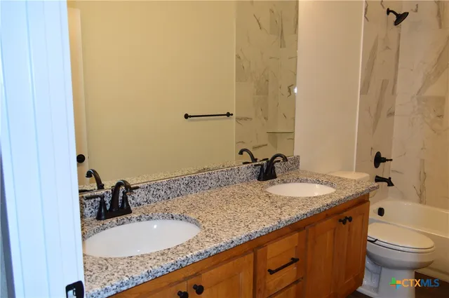 a view of cabinets and utility room with racks on the wall