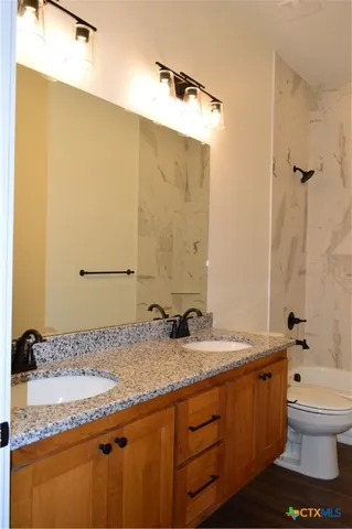 a bathroom with a sink a mirror and vanity