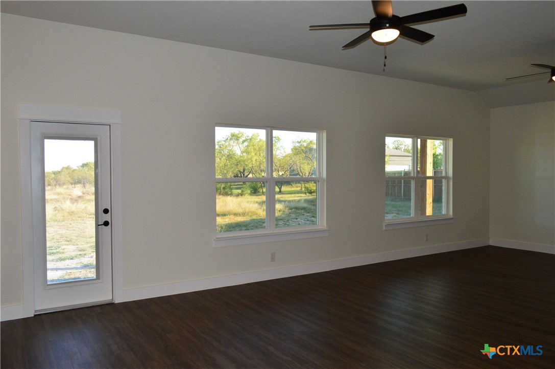425 County Road 3152 Kempner, TX 76539 - Photo 7 of 48 a view of an empty room with wooden floor and a window