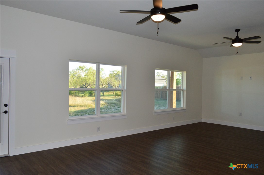 425 County Road 3152 Kempner, TX 76539 - Photo 8 of 48 a view of an empty room with wooden floor and a window