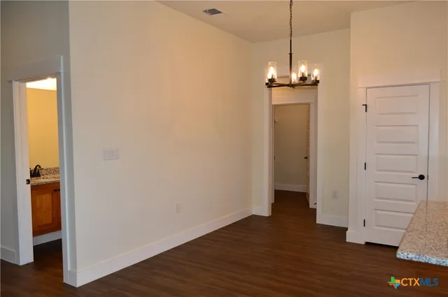 a view of a room with wooden floor and entryway
