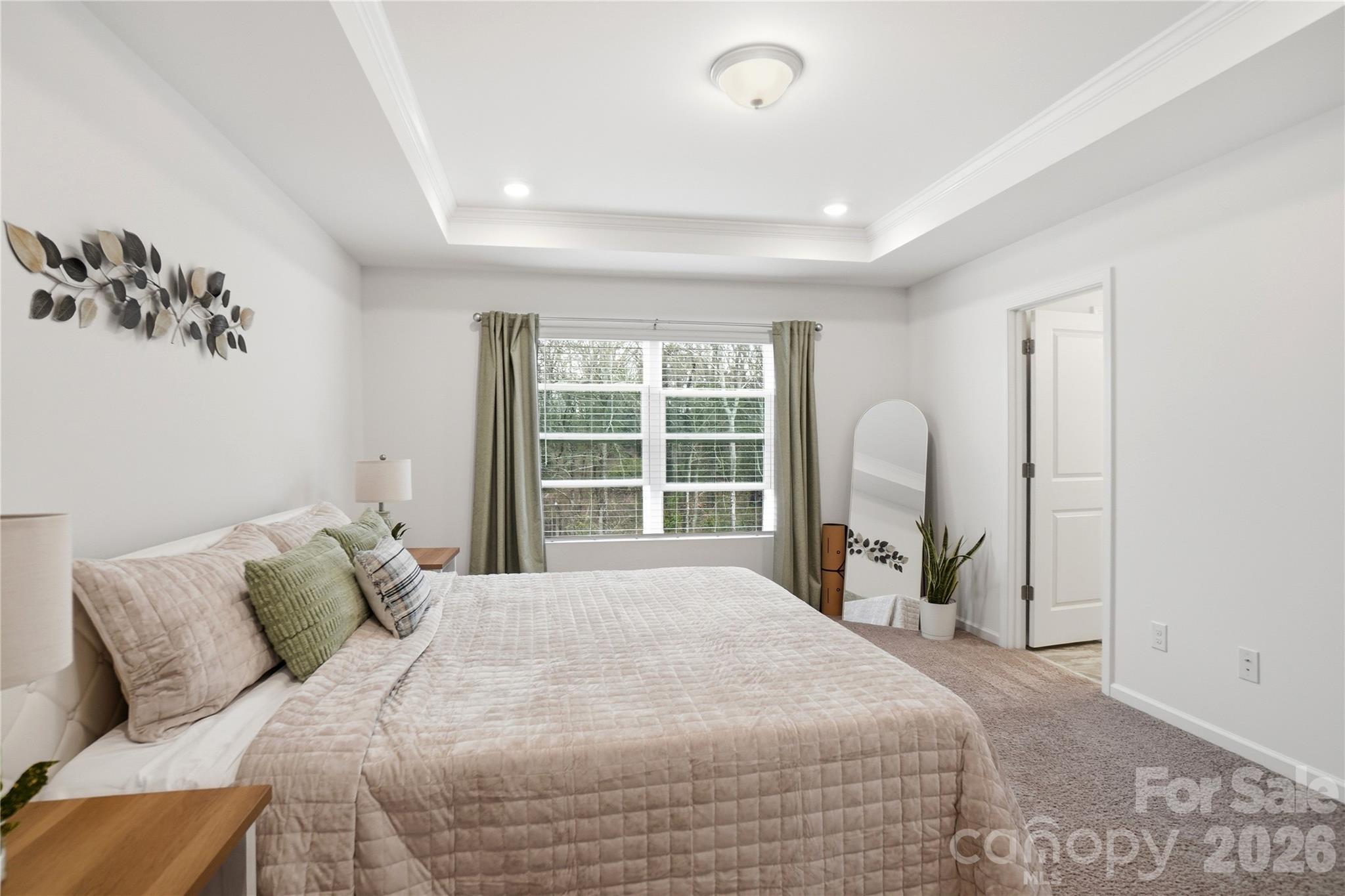 3574 Nimbell Road Monroe, NC 28110 - Photo 18 of 29 a large bed sitting in a bedroom next to a window and a chandelier