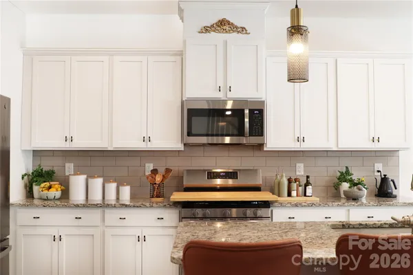 a bathroom with a bathtub shower sink vanity mirror and toilet