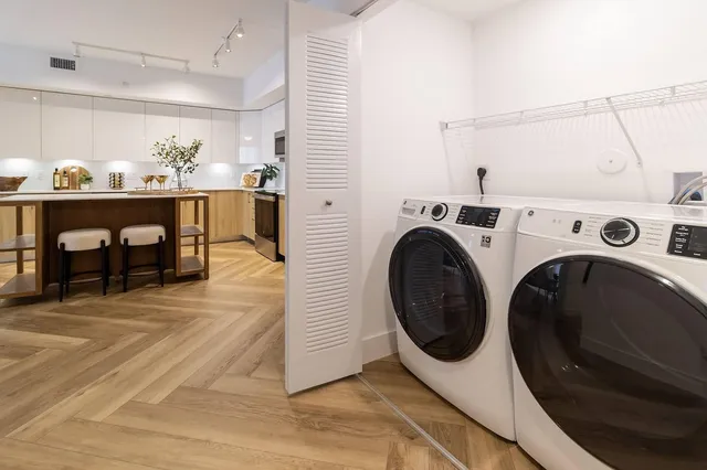 a utility room with closet dryer and washer