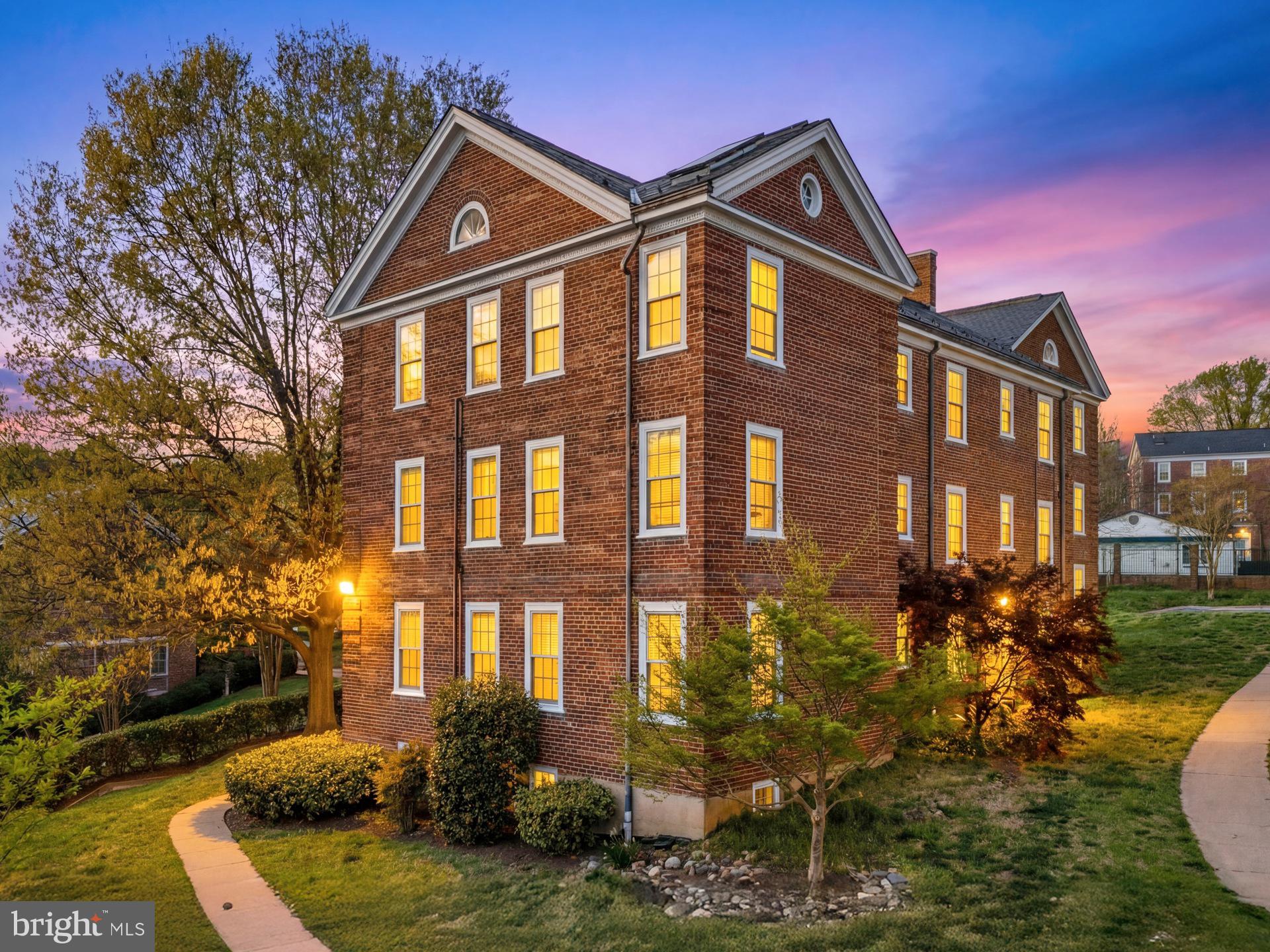 a front view of a residential apartment building with a yard