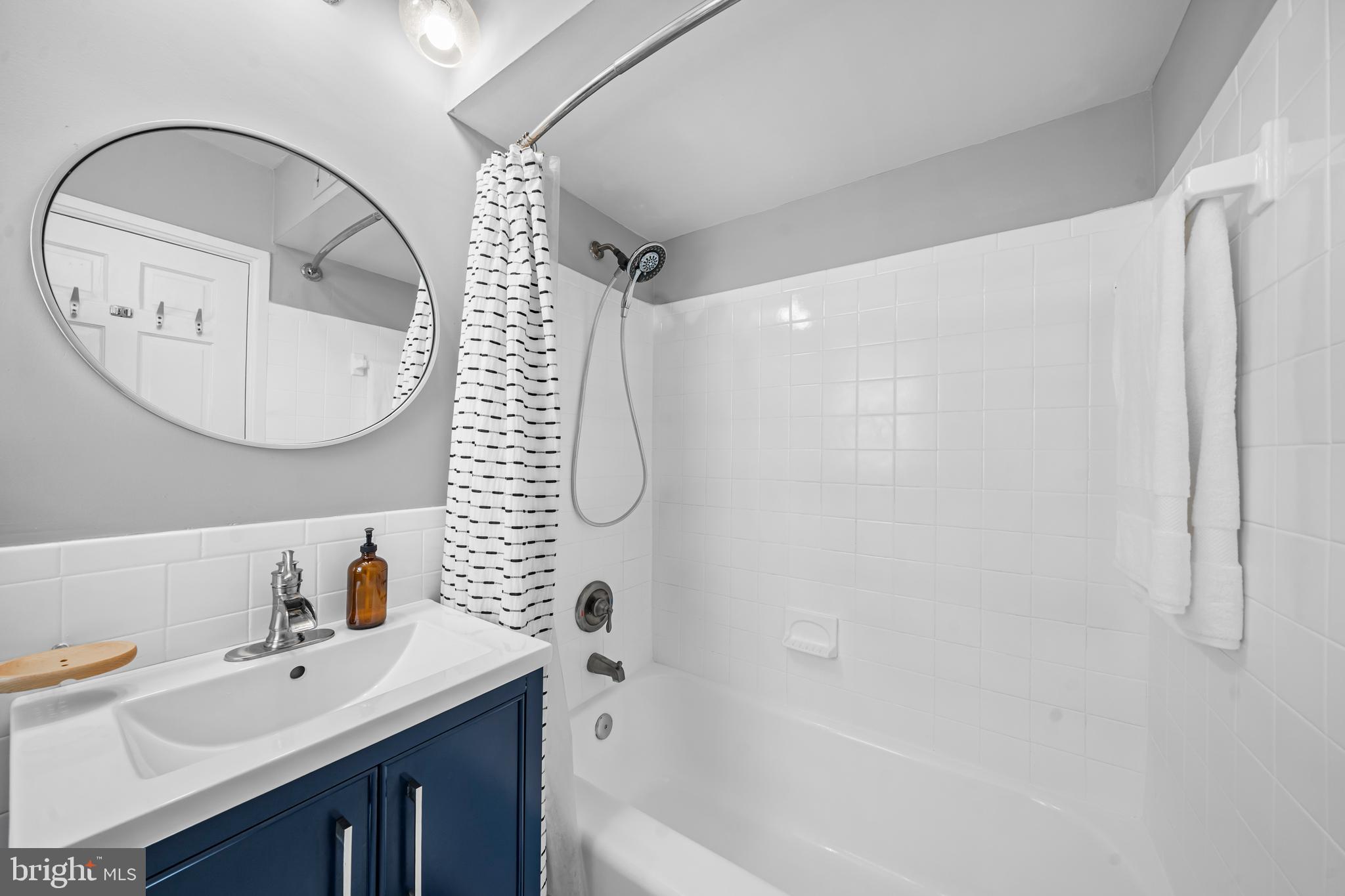 3861 Porter Street Northwest, Unit C285 Washington, DC 20016 - Photo 14 of 23 a bathroom with a sink a toilet and a mirror