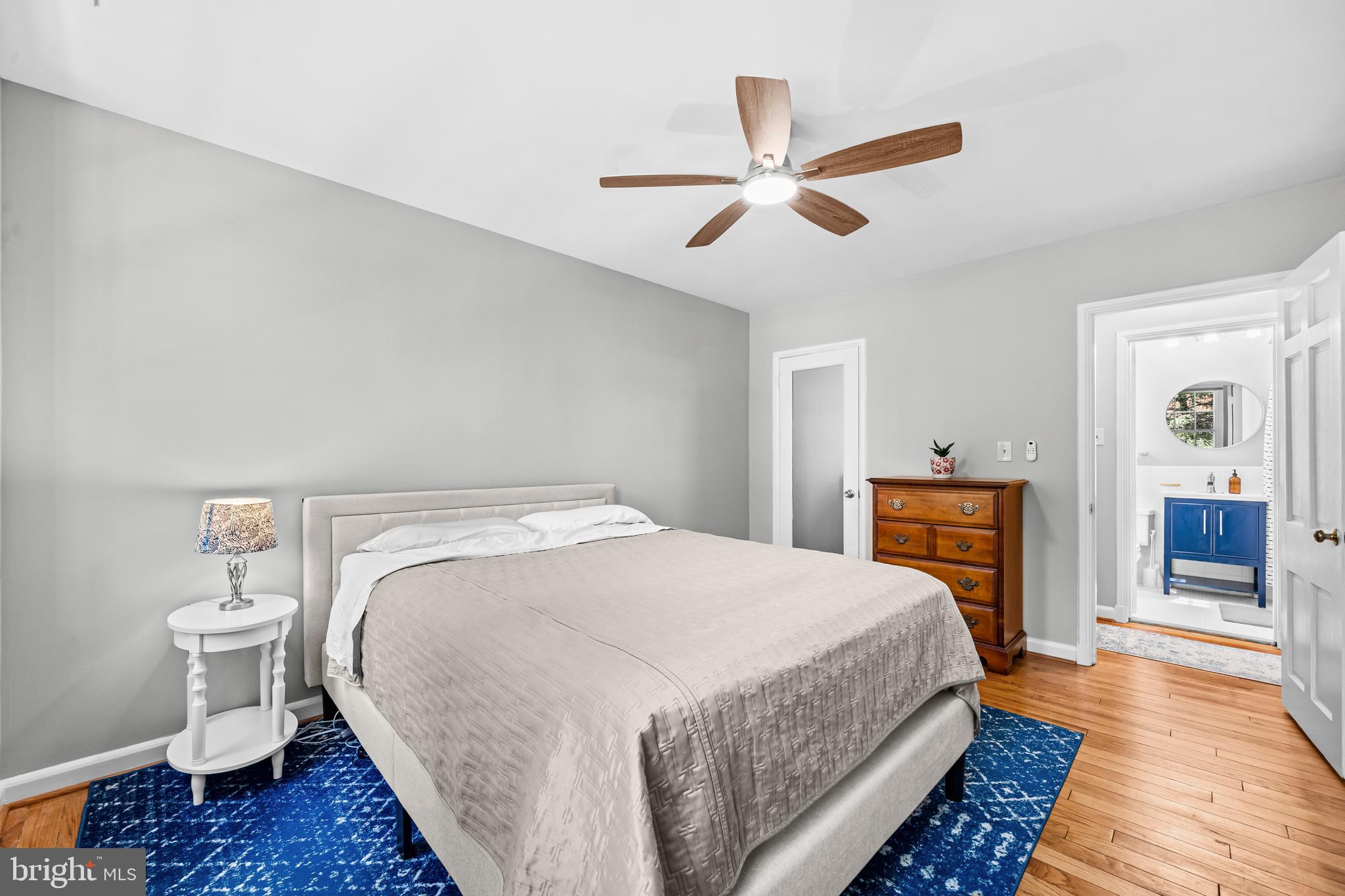 3861 Porter Street Northwest, Unit C285 Washington, DC 20016 - Photo 17 of 23 a spacious bedroom with a bed and wooden floor