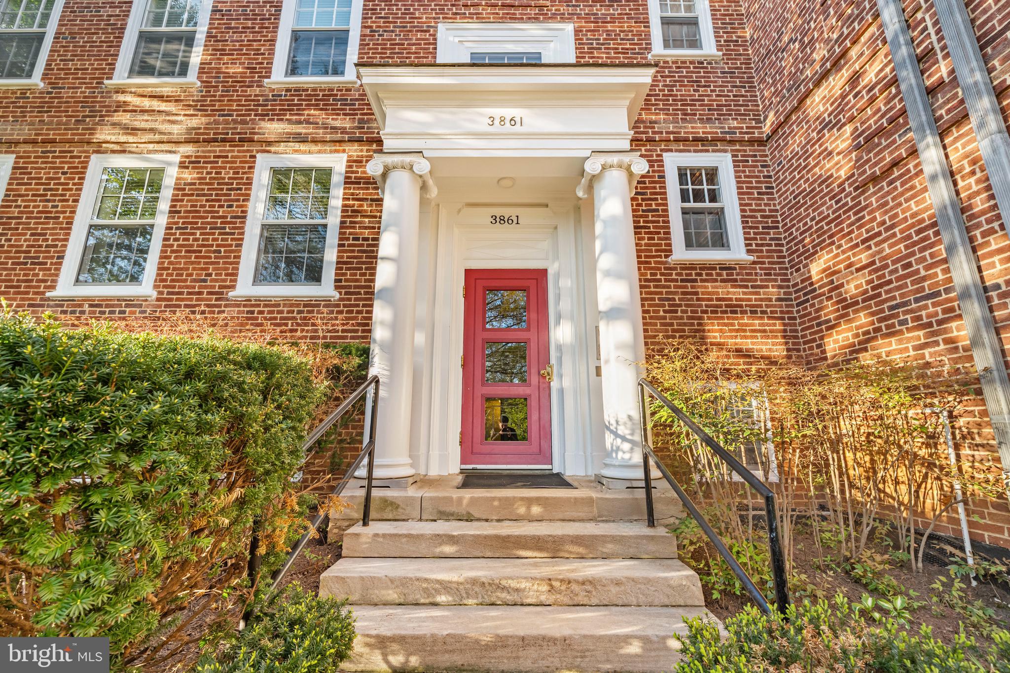 3861 Porter Street Northwest, Unit C285 Washington, DC 20016 - Photo 20 of 23 a view of a brick building with a small yard
