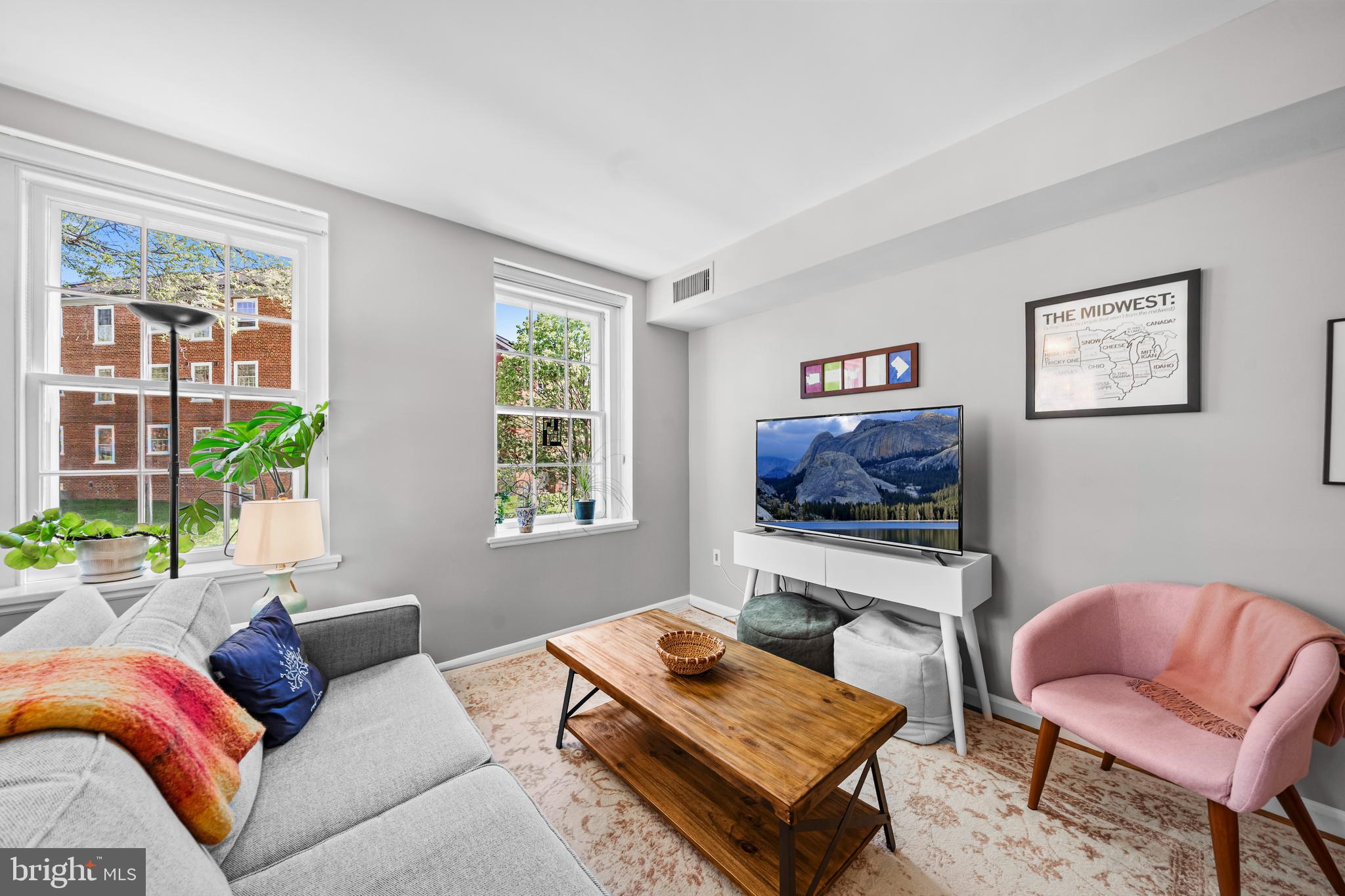 3861 Porter Street Northwest, Unit C285 Washington, DC 20016 - Photo 4 of 23 a living room with furniture a flat screen tv and a window