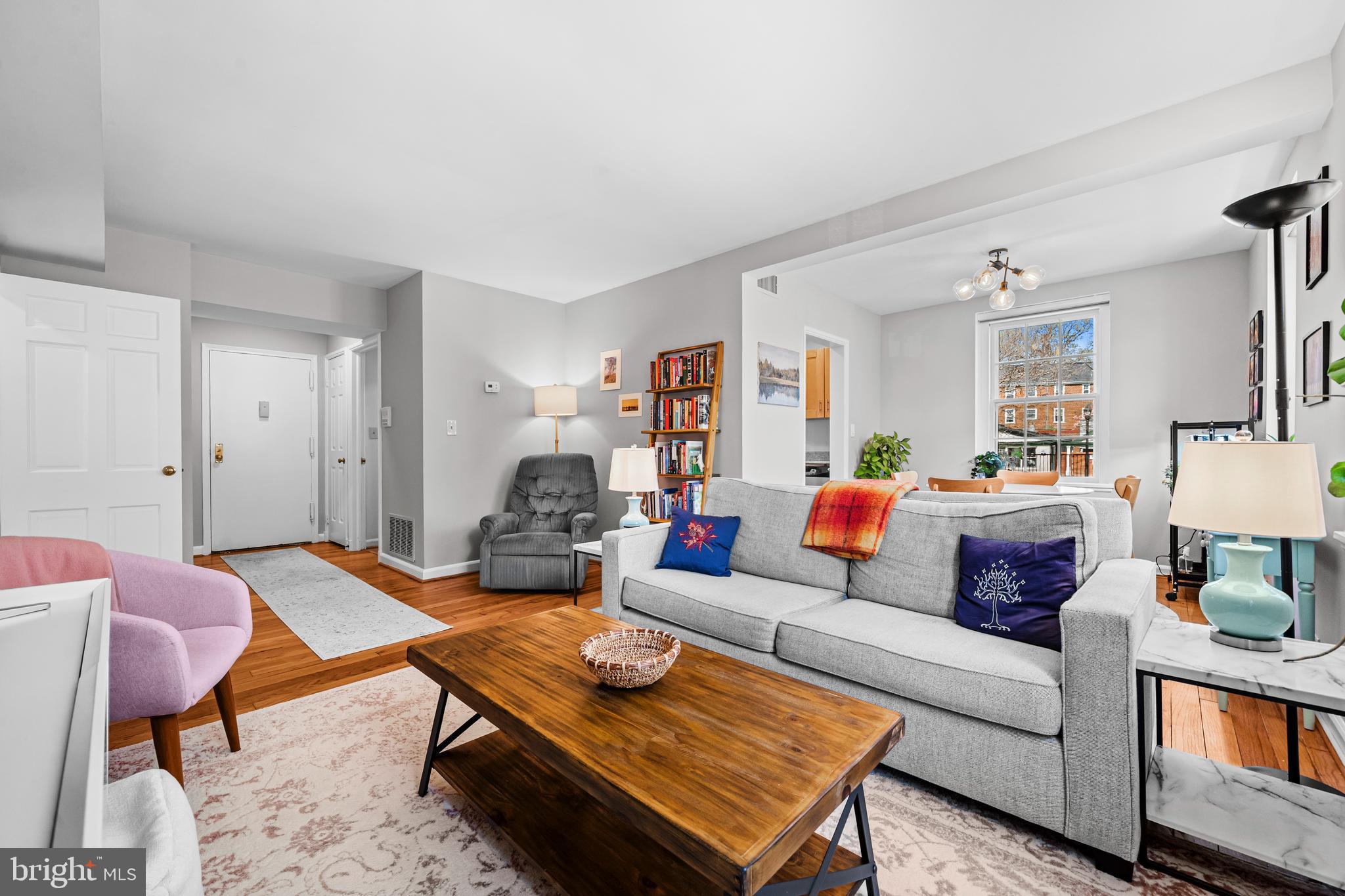3861 Porter Street Northwest, Unit C285 Washington, DC 20016 - Photo 5 of 23 a living room with furniture and a wooden floor