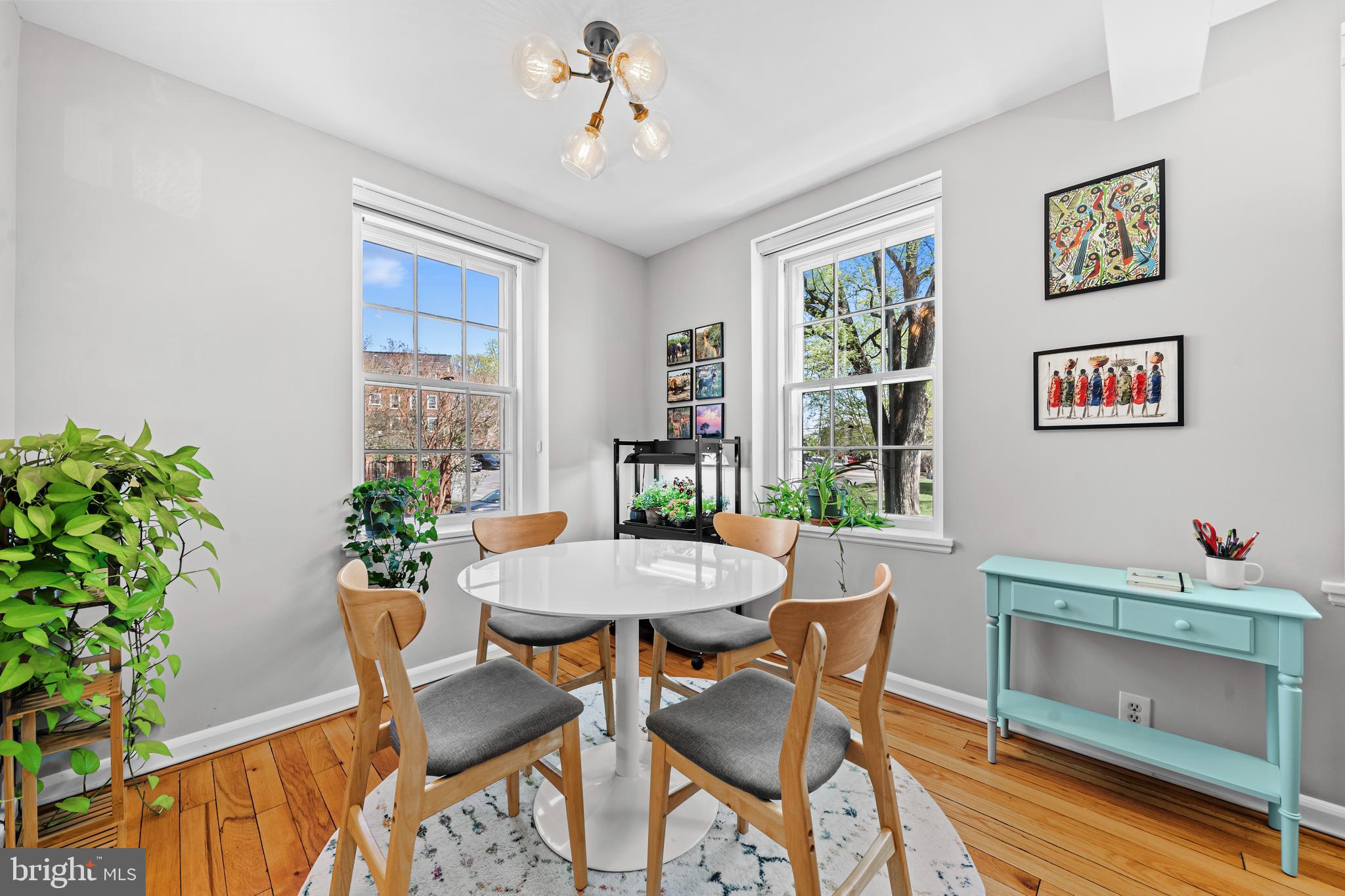 3861 Porter Street Northwest, Unit C285 Washington, DC 20016 - Photo 6 of 23 a dining room with furniture potted plants and wooden floor