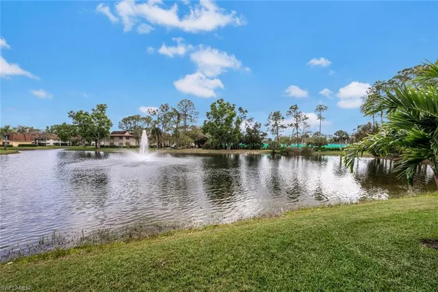 a view of a lake with houses in the back