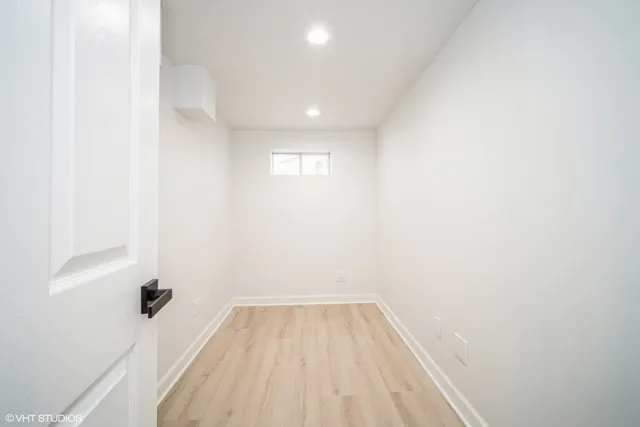 a view of a room with wooden floor and a sink