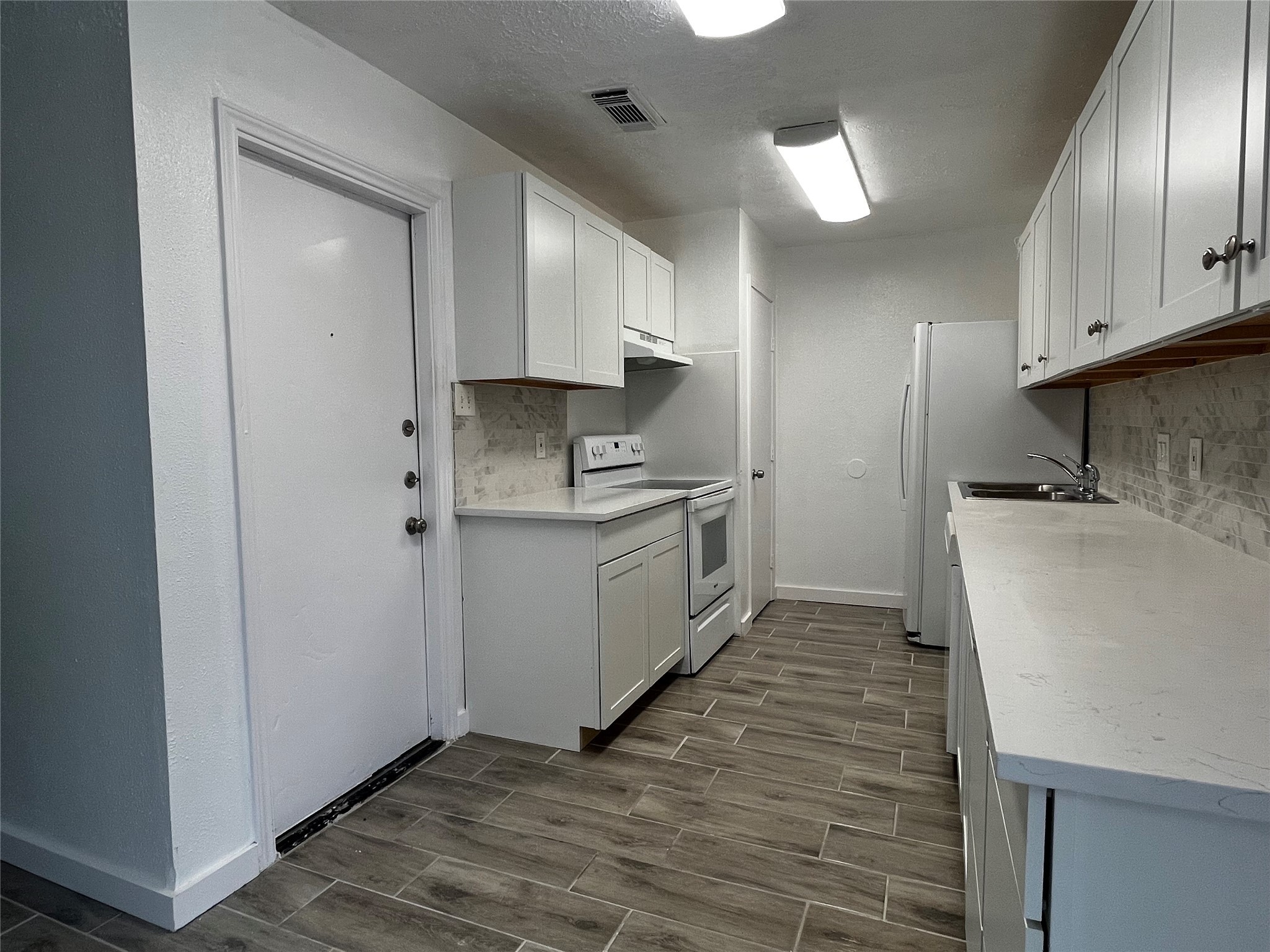 4434 Donalbain Drive Spring, TX 77373 - Photo 11 of 23 a kitchen with a sink a stove and cabinets
