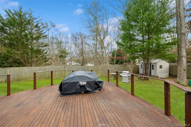 a view of a wooden deck and a yard