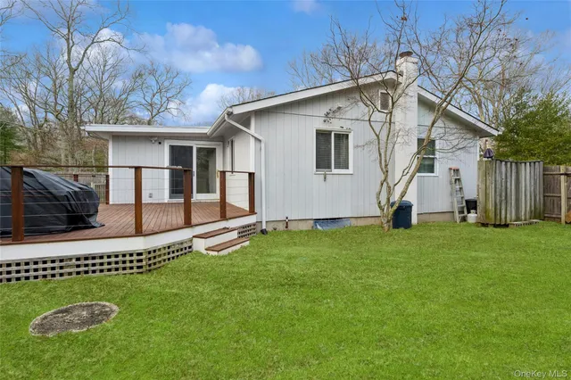 a white house that has tree in front of it