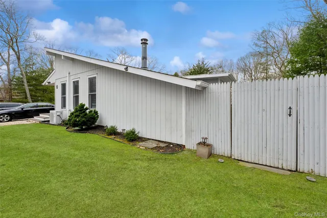 a backyard of a house with table and chairs