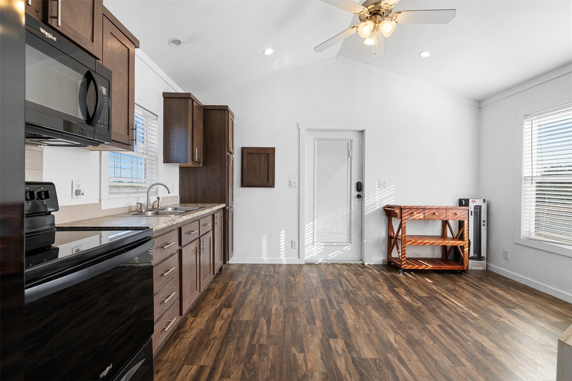 3270 Fm 671 Luling, TX 78648 - Photo 6 of 35 Kitchen featuring black appliances, dark wood-style floors, light countertops, lofted ceiling, and ceiling fan