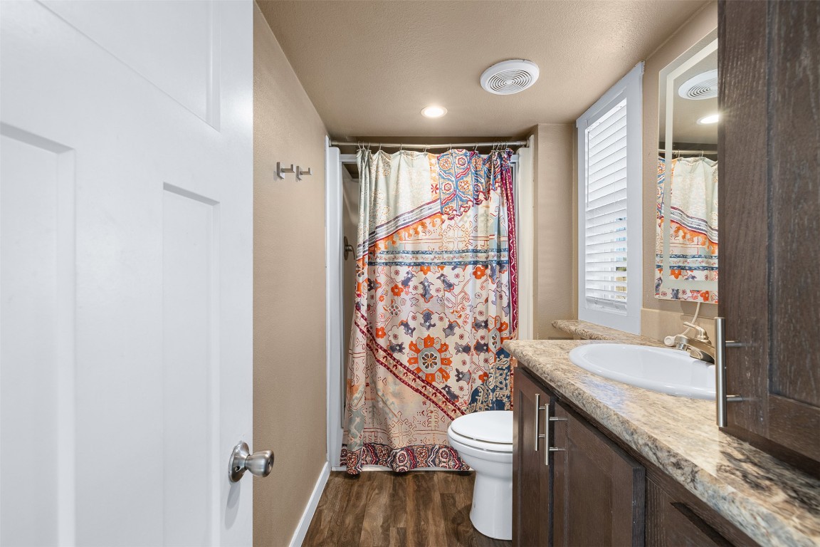 3270 Fm 671 Luling, TX 78648 - Photo 7 of 35 a bathroom with a granite countertop sink a toilet and shower curtain
