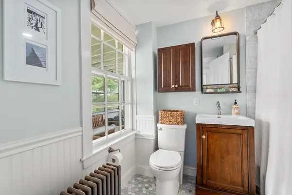 a bathroom with a sink a toilet and a mirror