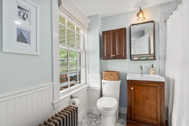 a bathroom with a sink a toilet and a mirror