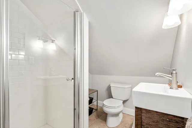 a white toilet sitting next to a bathroom sink