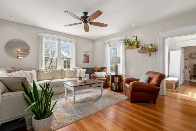 a living room with furniture and wooden floor