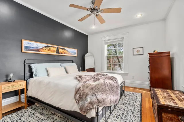 a bedroom with a bed and dresser with mirror