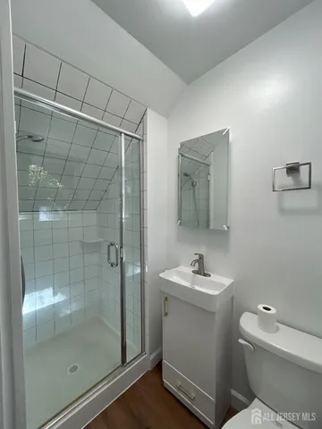 a bathroom with a shower a toilet and sink