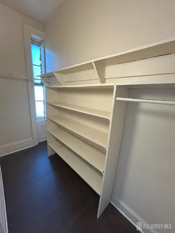 a view of walk in closet with empty racks