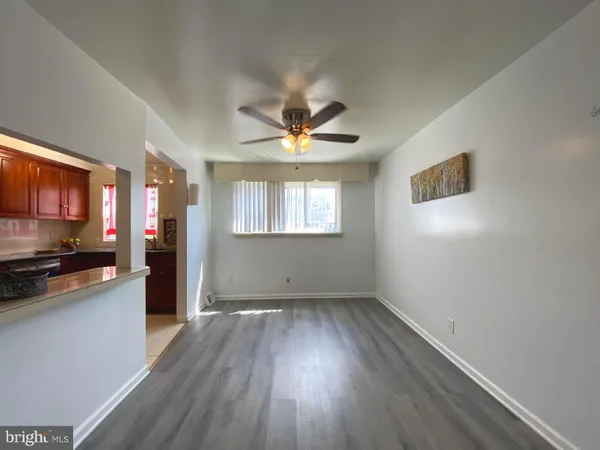 a view of a kitchen with wooden floor and a window