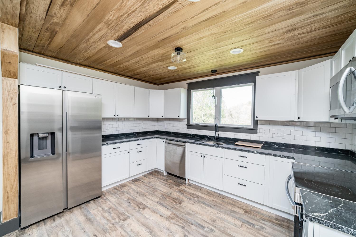 237 Lexington Turnpike Amherst, VA 24521 - Photo 29 of 56 a kitchen with granite countertop a sink stainless steel appliances and cabinets