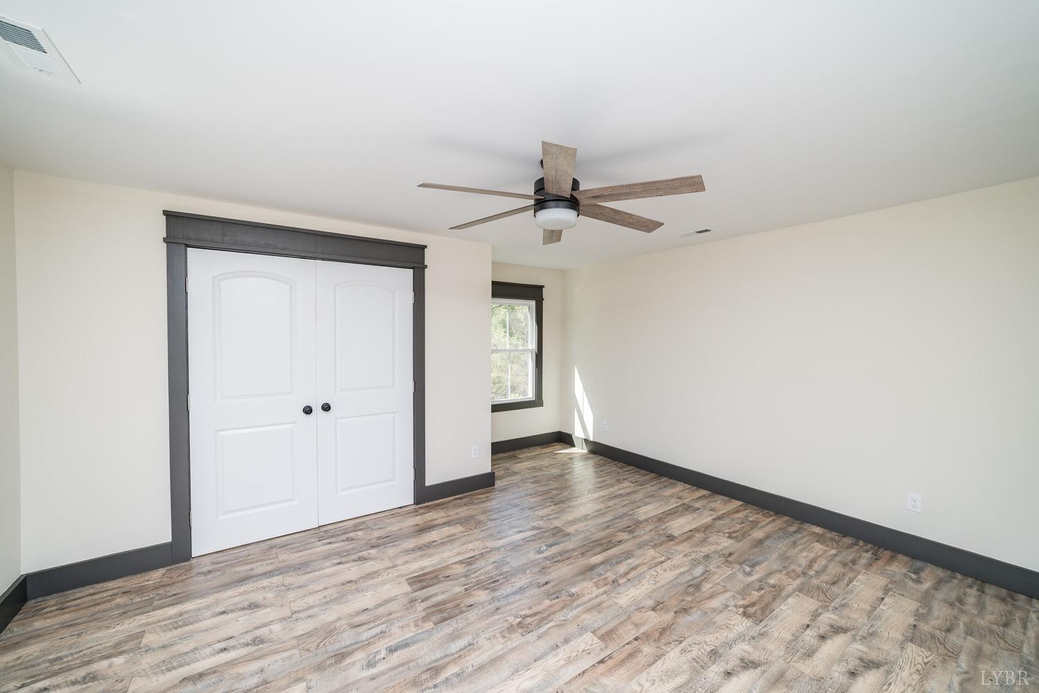 237 Lexington Turnpike Amherst, VA 24521 - Photo 47 of 56 a view of an empty room with wooden floor and a ceiling fan