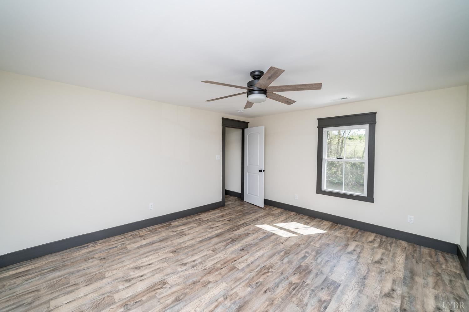 237 Lexington Turnpike Amherst, VA 24521 - Photo 48 of 56 a view of a big room with wooden floor ceiling fan and windows