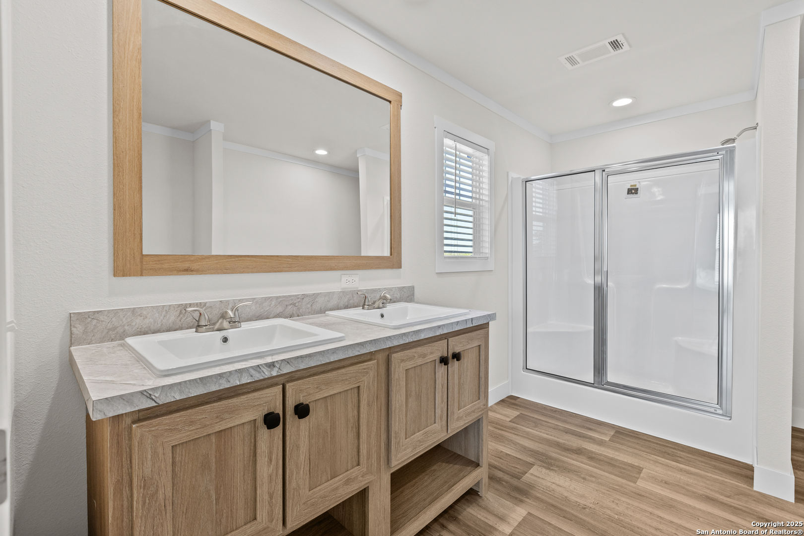 2354 Stevens Road Somerset, TX 78069 - Photo 15 of 22 a bathroom with a sink a mirror and a shower