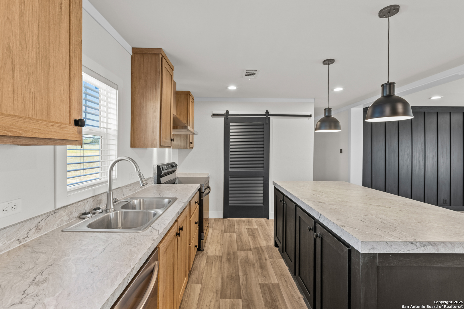 2354 Stevens Road Somerset, TX 78069 - Photo 8 of 22 a kitchen with stainless steel appliances granite countertop sink stove and refrigerator