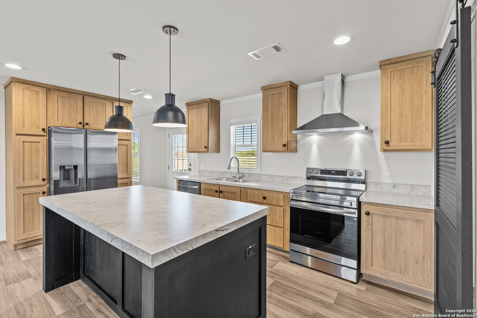 2354 Stevens Road Somerset, TX 78069 - Photo 10 of 22 a kitchen with stainless steel appliances granite countertop a sink a stove a refrigerator and island