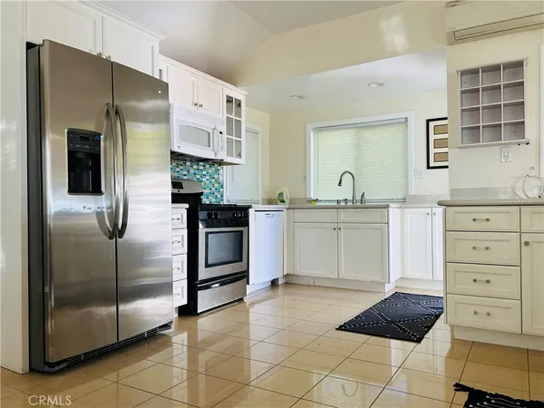 a kitchen with stainless steel appliances a refrigerator sink and cabinets