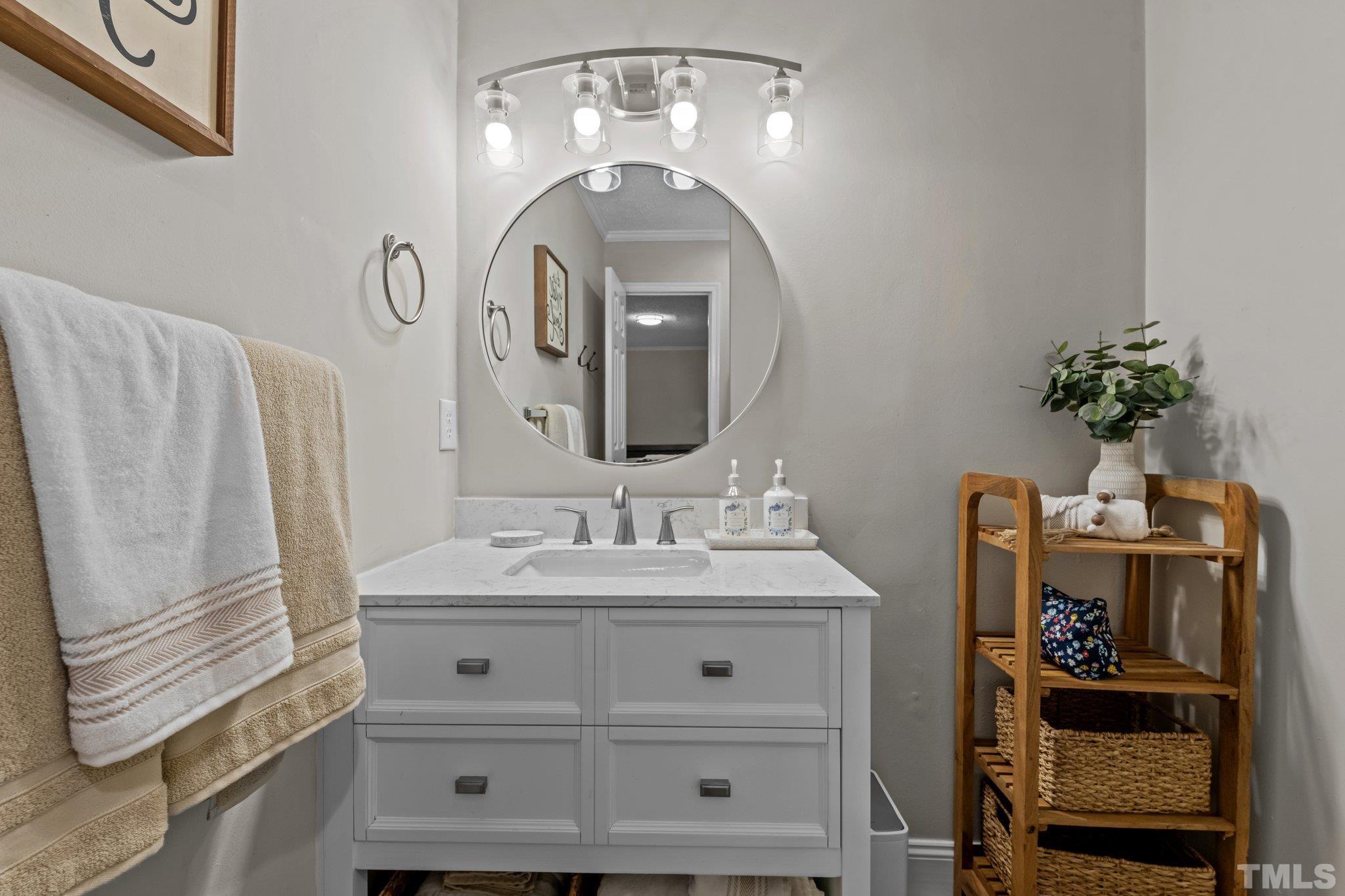 3717 Summer Place Raleigh, NC 27604 - Photo 13 of 26 a bathroom with a sink and a mirror