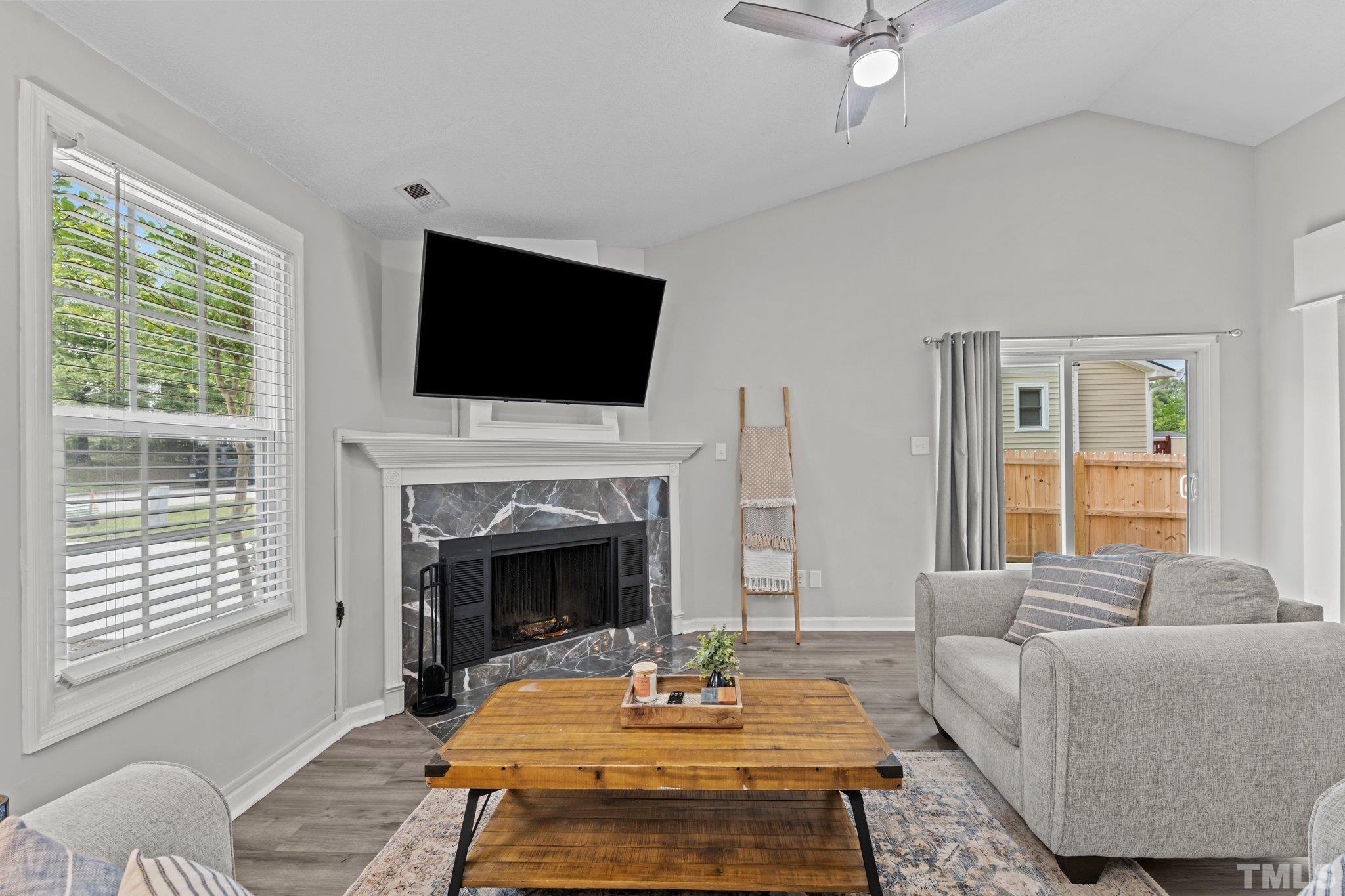 3717 Summer Place Raleigh, NC 27604 - Photo 5 of 26 a living room with furniture a fireplace and a flat screen tv