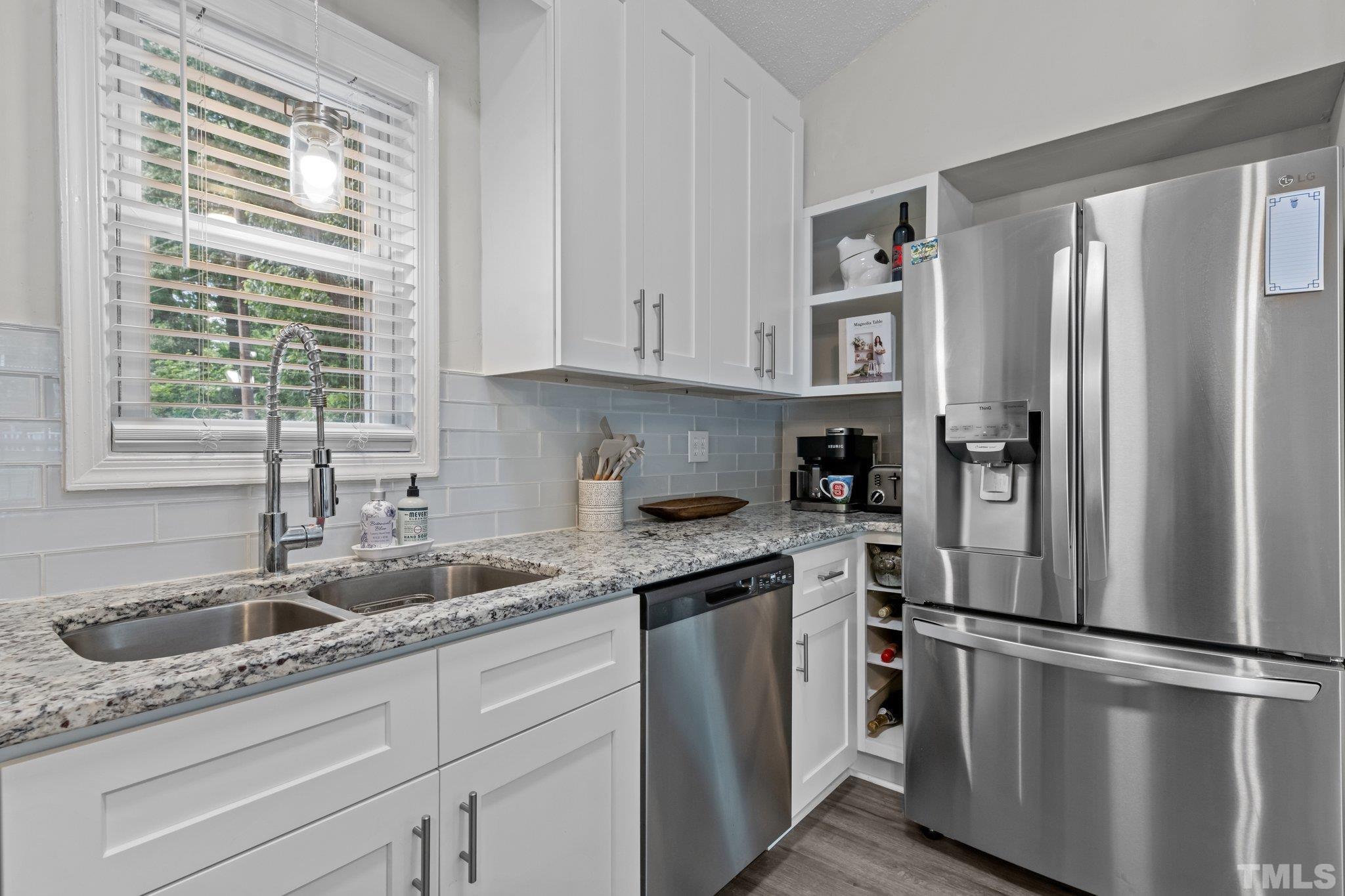 3717 Summer Place Raleigh, NC 27604 - Photo 8 of 26 a kitchen with stainless steel appliances granite countertop a refrigerator sink and cabinets