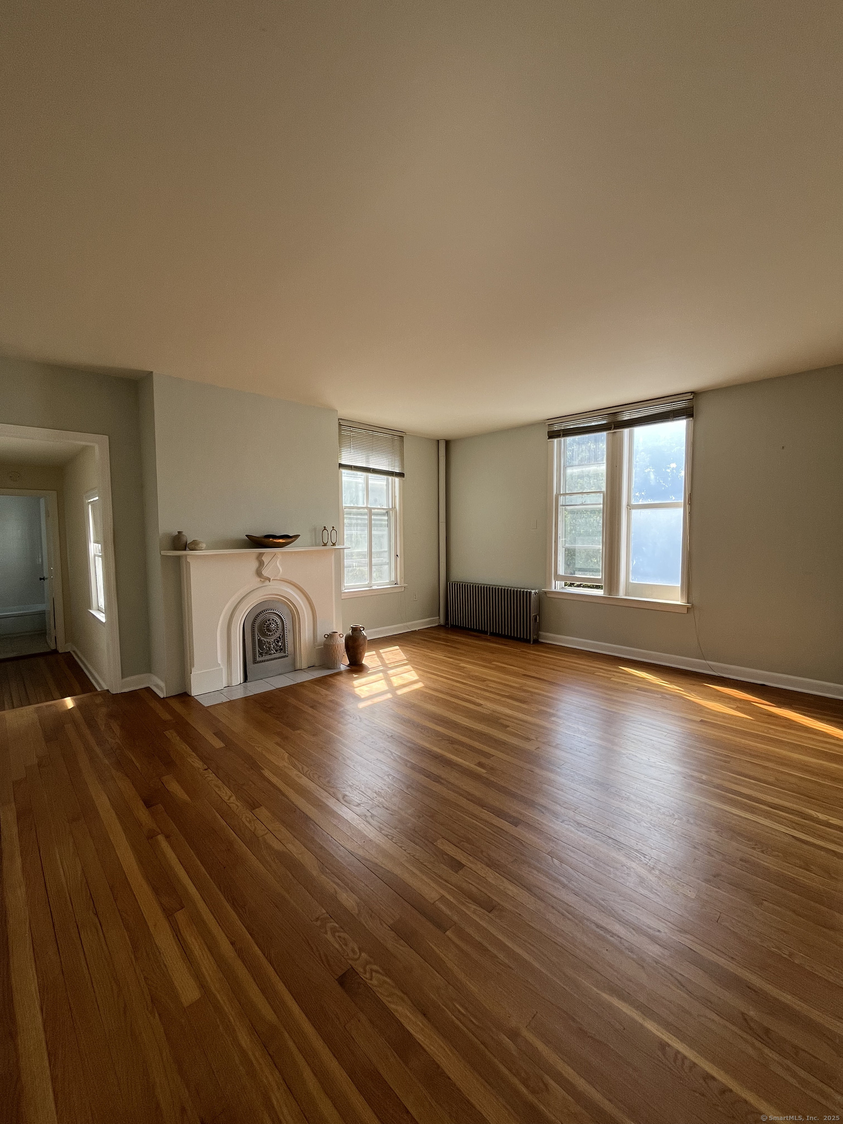 a view of a livingroom with wooden floor and window