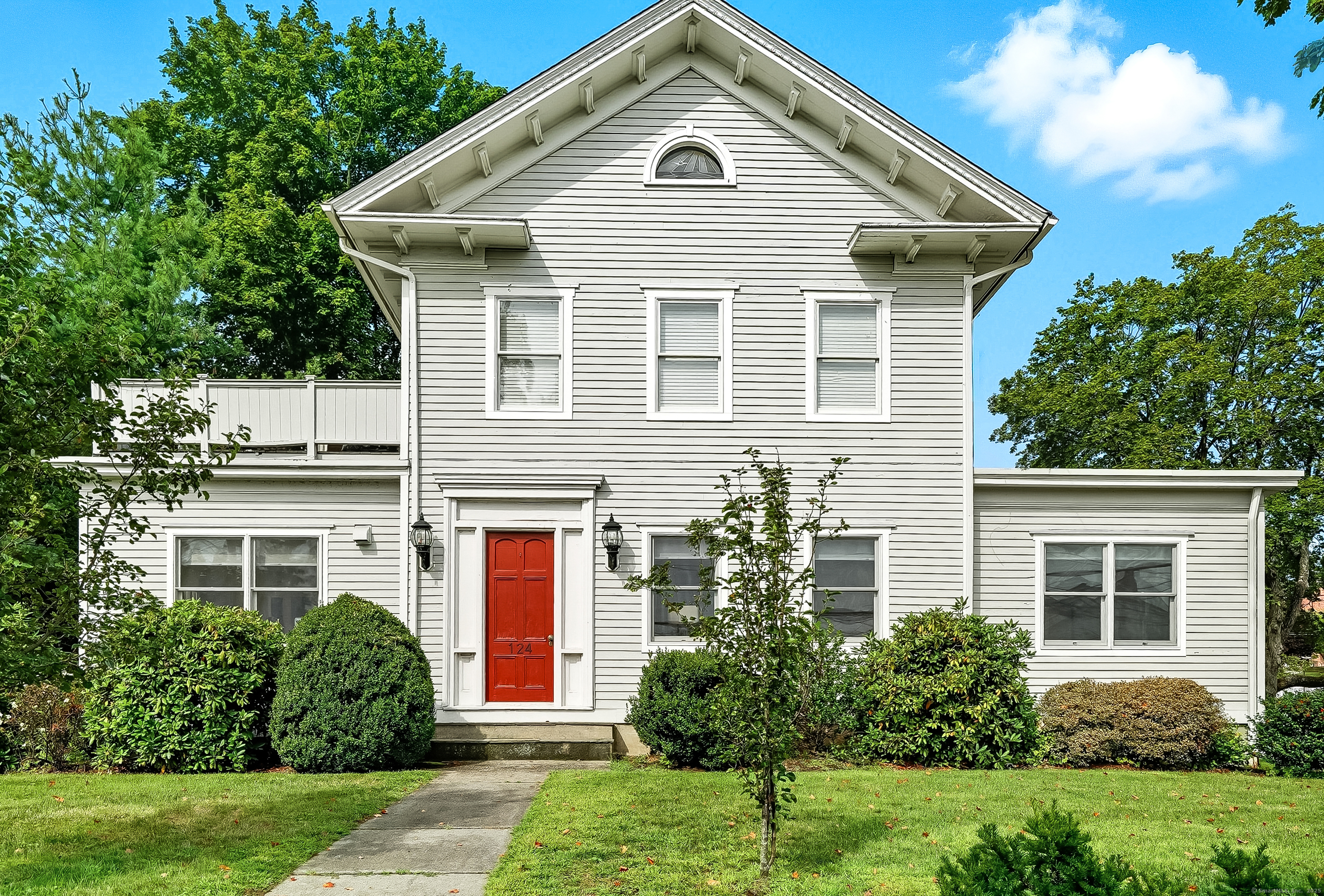 124 Riverside Avenue, Unit 2 Westport, CT 06880 - Photo 1 of 1 a front view of a house with a yard