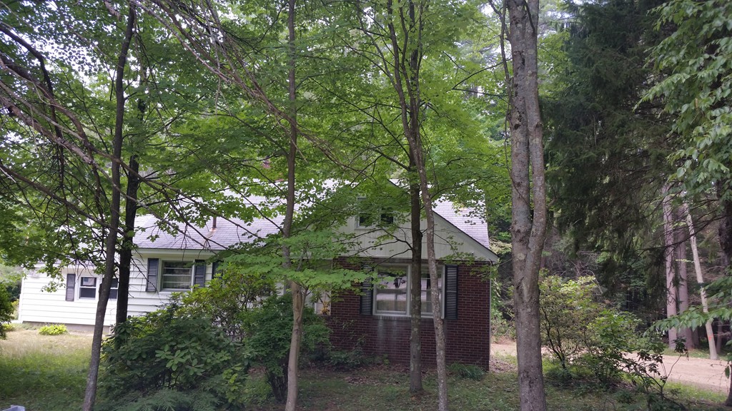 715 Petersham Road Athol, MA 01331 - Photo 1 of 13 a house is sitting in middle of forest