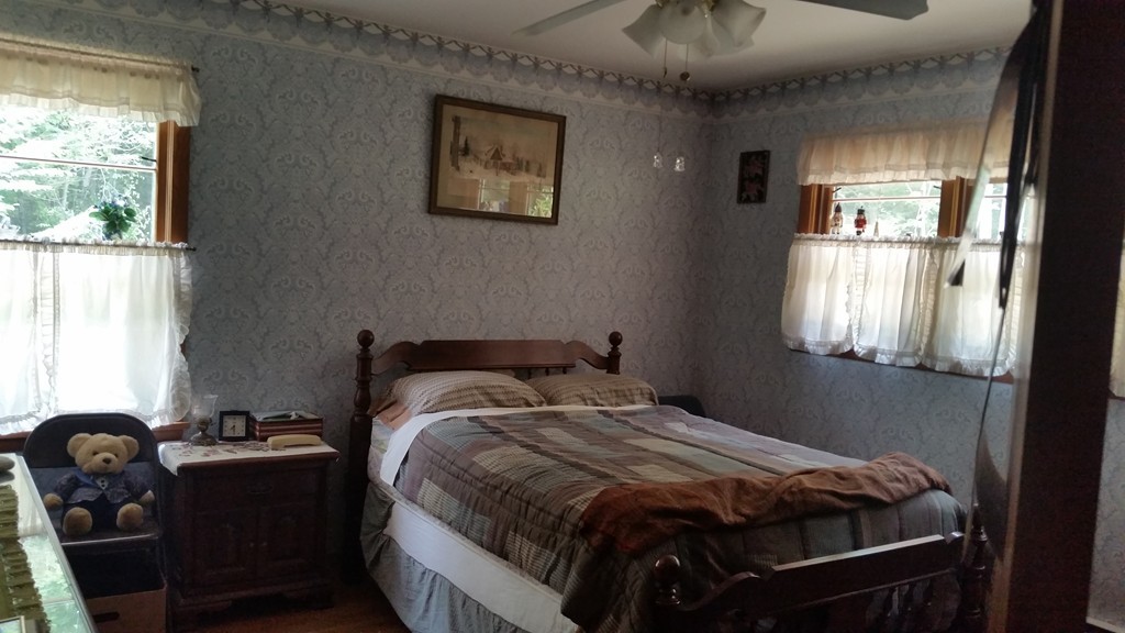 715 Petersham Road Athol, MA 01331 - Photo 9 of 13 a bedroom with a bed and wooden floor