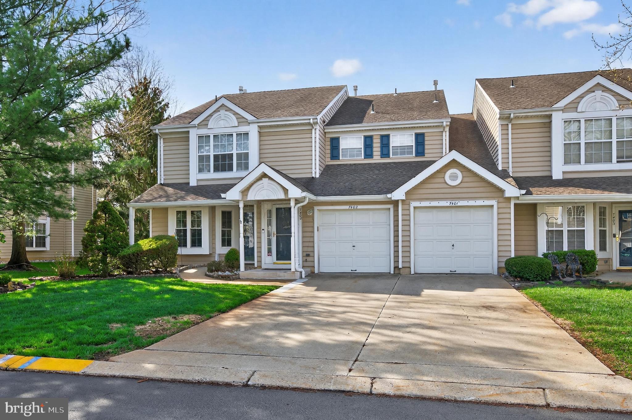 7401A Normandy Drive Mount Laurel, NJ 08054 - Photo 2 of 35 a front view of a house with a yard and garage
