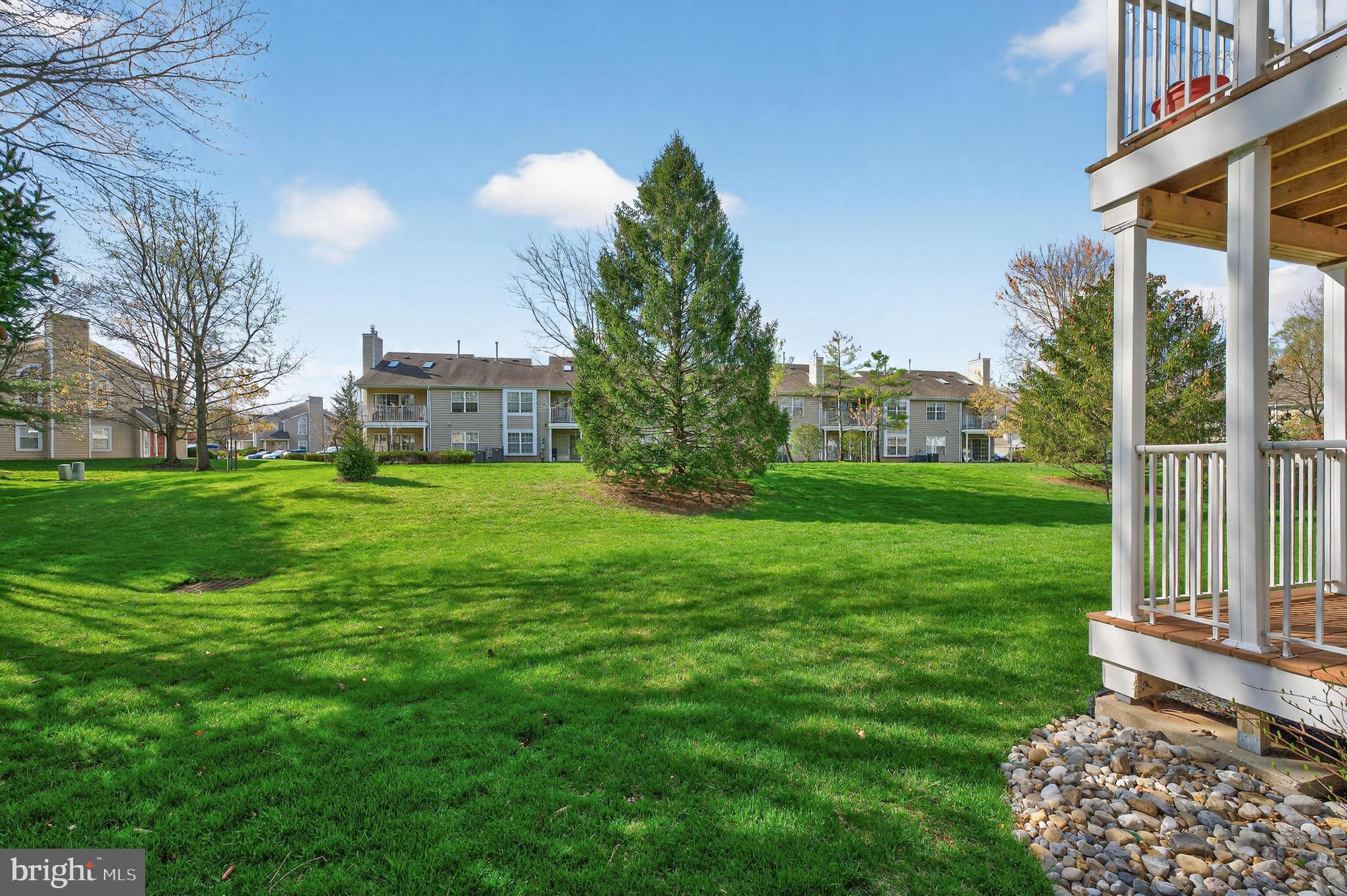 7401A Normandy Drive Mount Laurel, NJ 08054 - Photo 24 of 35 a view of a garden with a building in the background