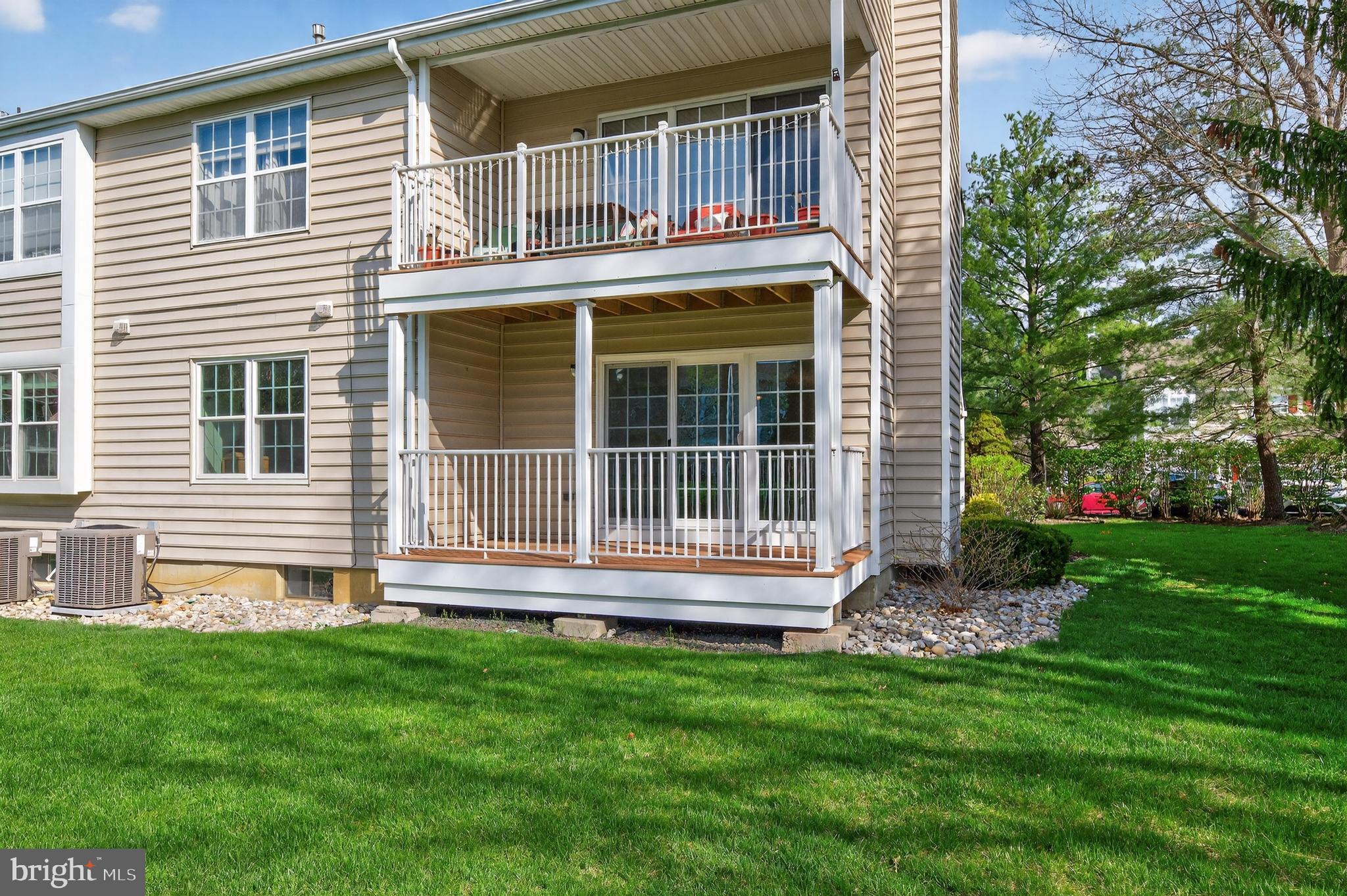 7401A Normandy Drive Mount Laurel, NJ 08054 - Photo 25 of 35 a front view of a house with a yard