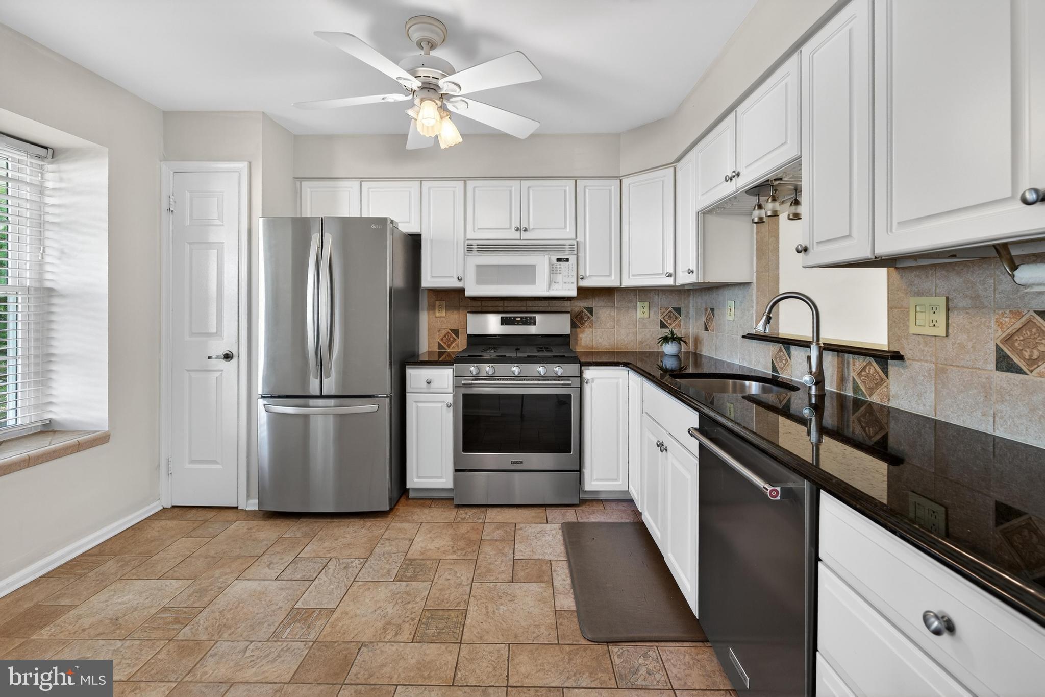 7401A Normandy Drive Mount Laurel, NJ 08054 - Photo 5 of 35 a kitchen with a refrigerator a sink and dishwasher