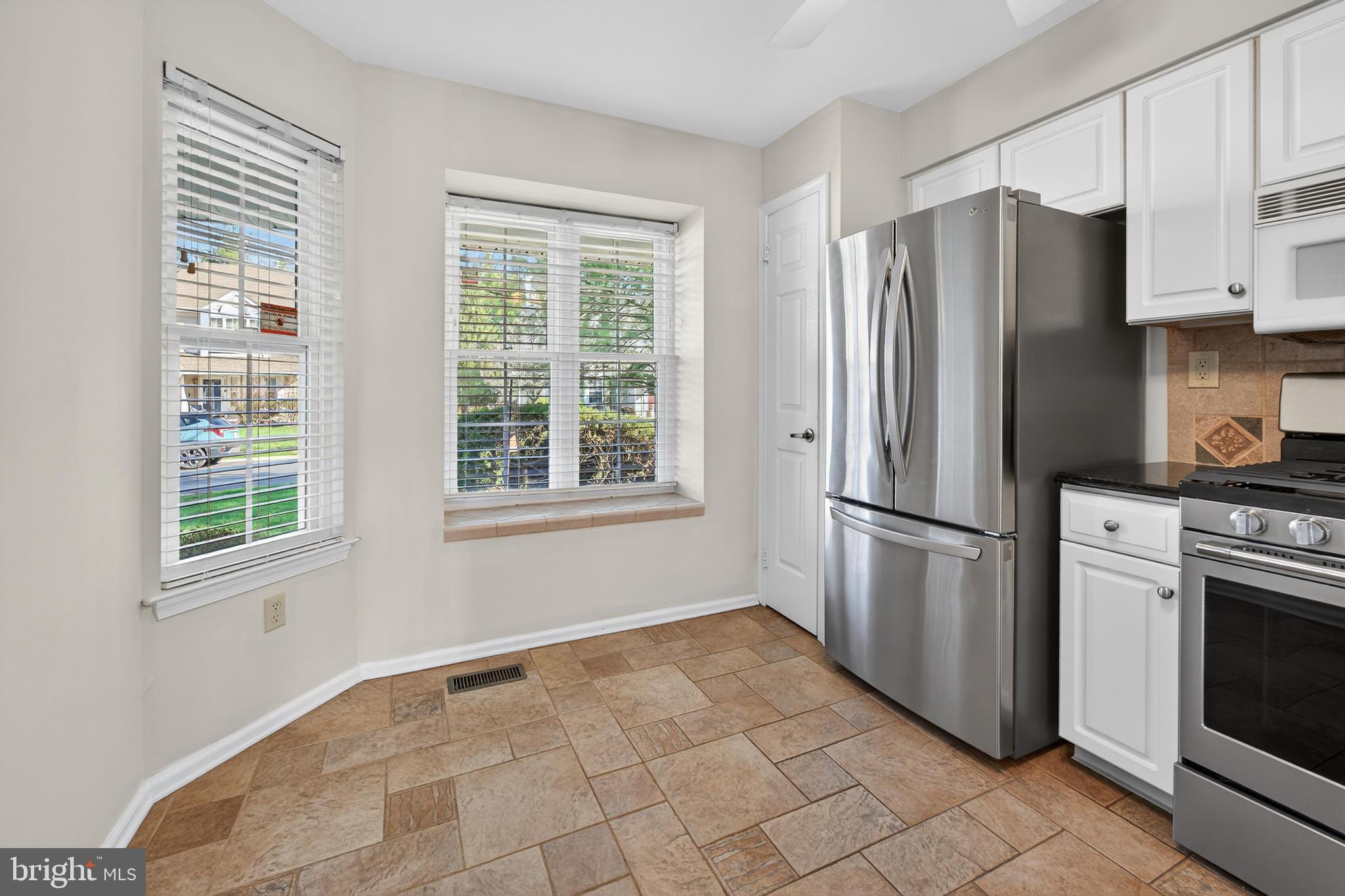 7401A Normandy Drive Mount Laurel, NJ 08054 - Photo 7 of 35 a kitchen with stainless steel appliances a refrigerator sink and cabinets